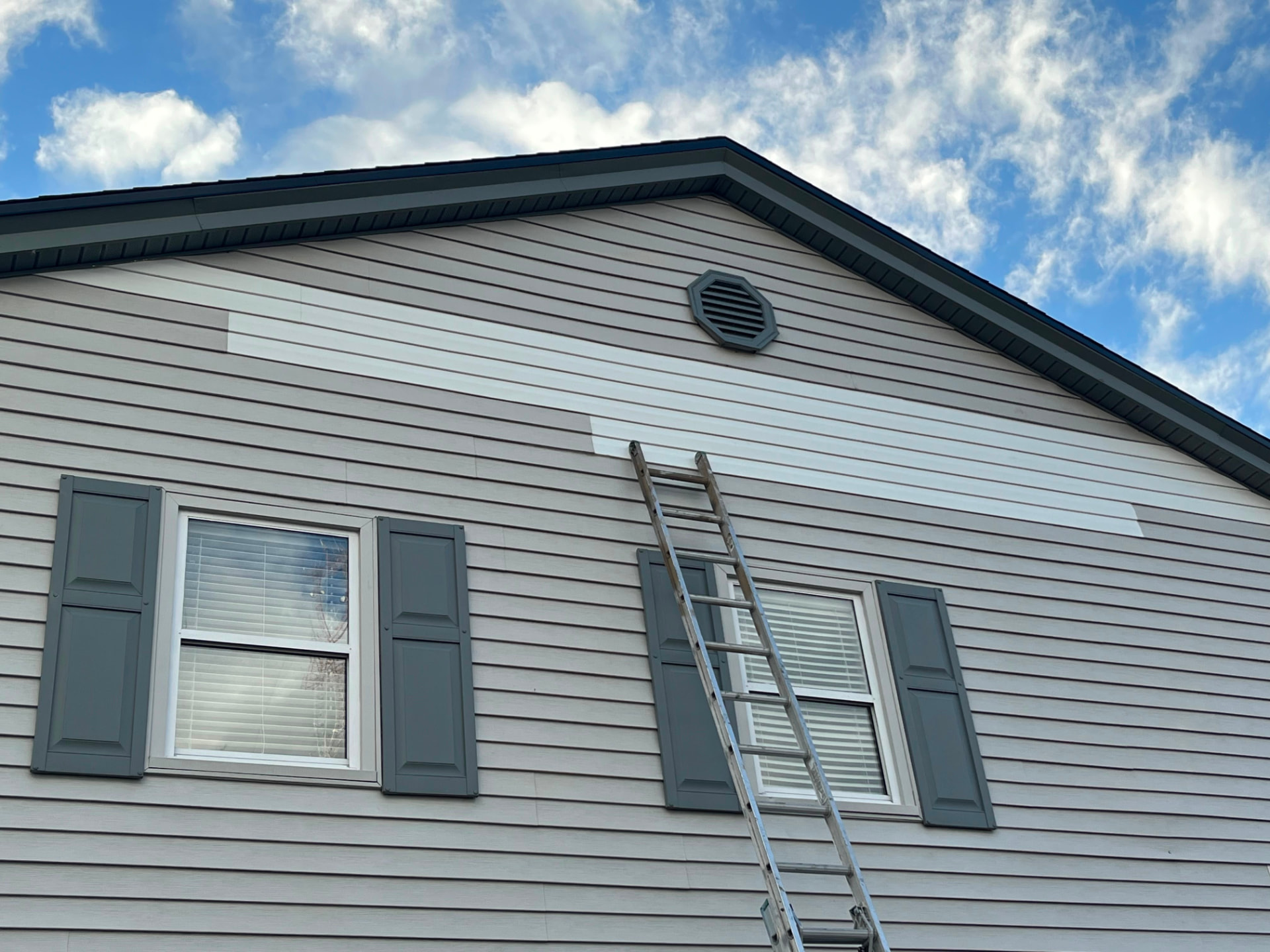 Exterior siding prep and repaint in progress