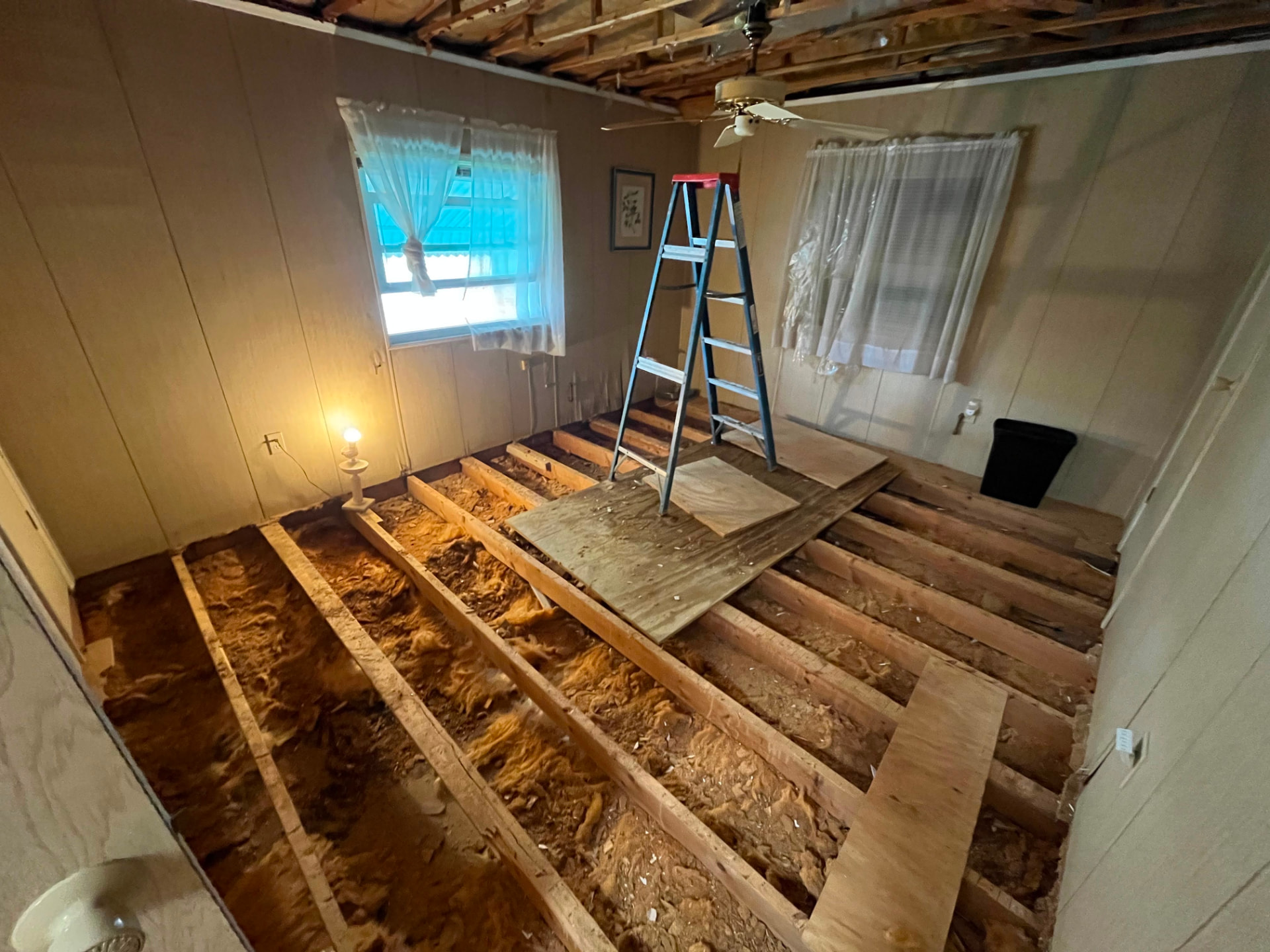 Subfloor and ceiling tear-out during a full room rebuild