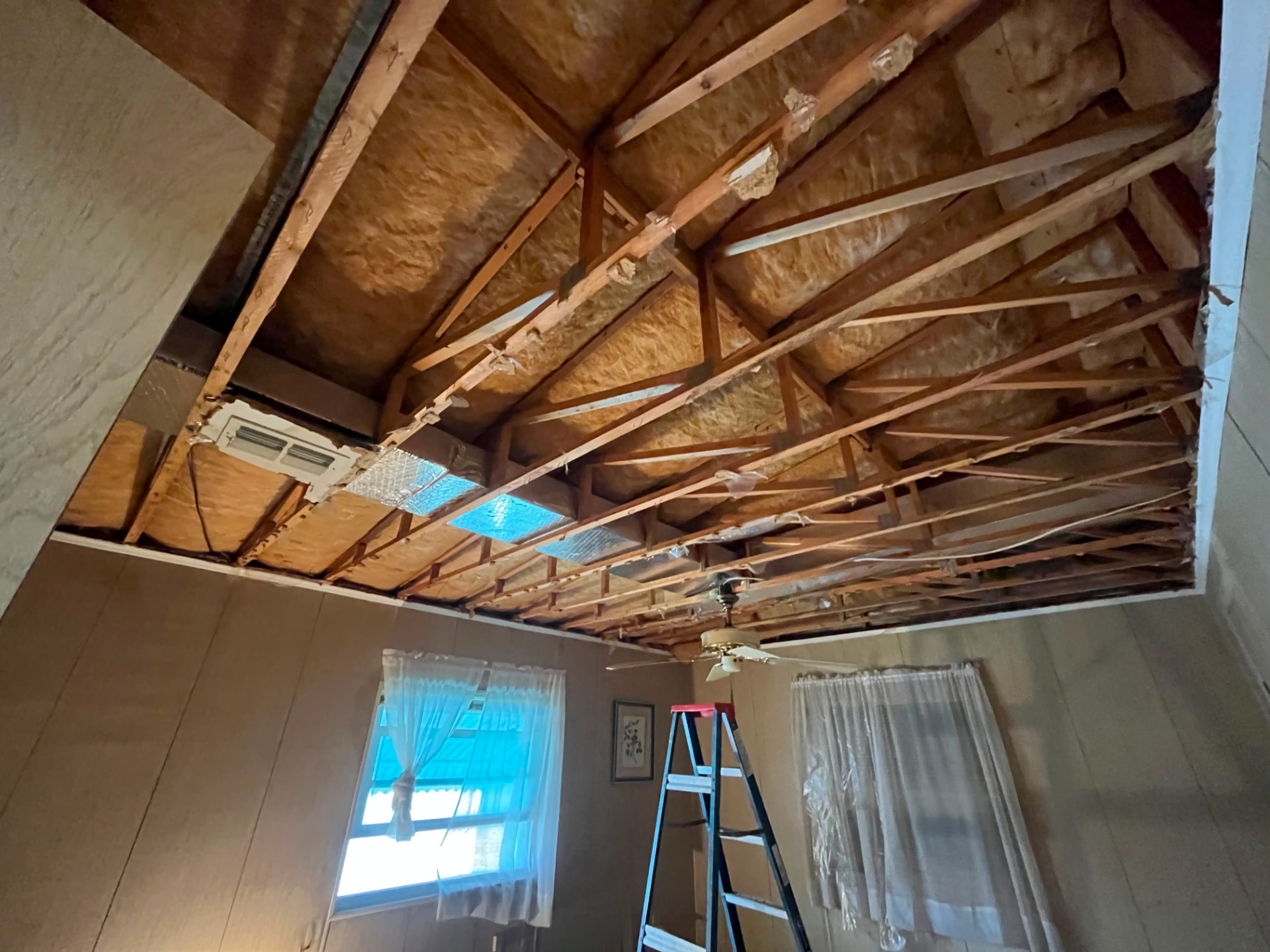 Ceiling opened up to expose trusses, insulation and ductwork
